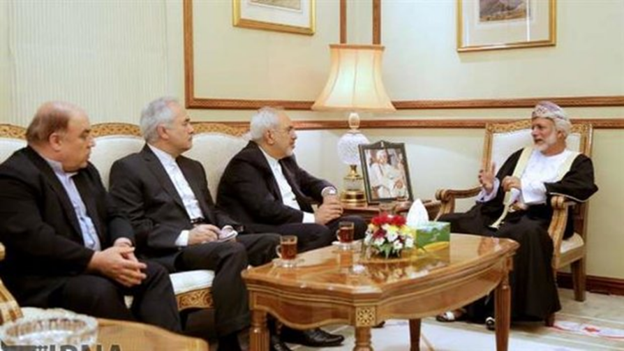 Diplomatic meeting between officials in Oman and Iran, seated in a formal room with traditional attire and suits