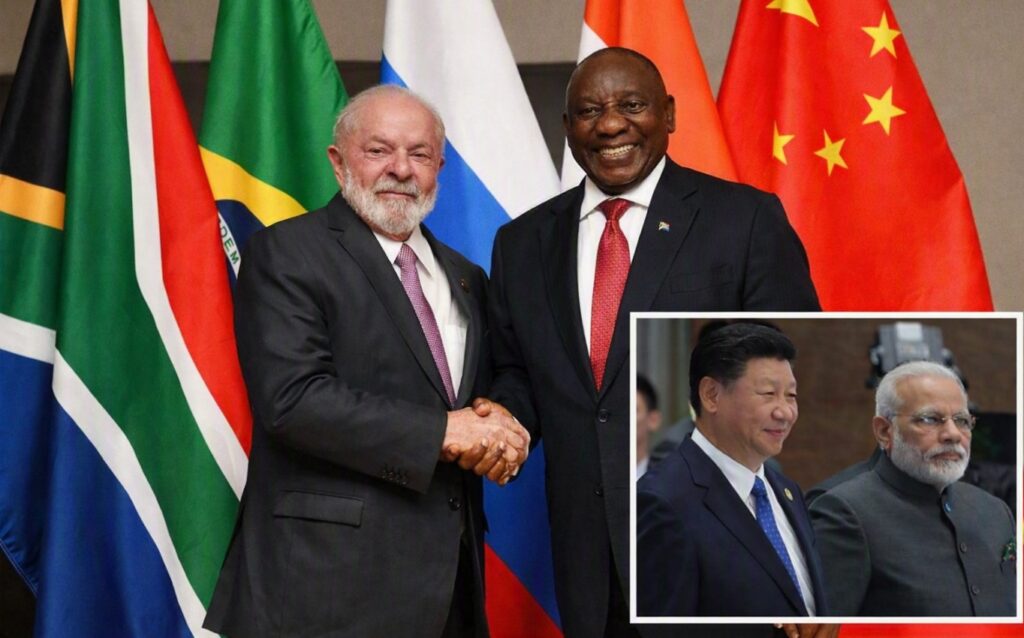 BRICS leaders shaking hands in front of national flags representing Brazil, Russia, India, China, and South Africa during a diplomatic meeting.