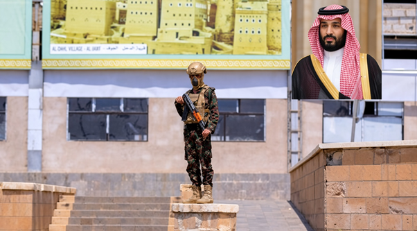 Yemeni soldier on patrol near Al-Dhail village, with Saudi Crown Prince MBS inset