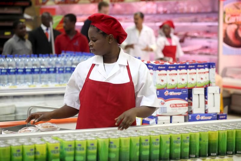 South African supermarket worker packing stock during a retail shift