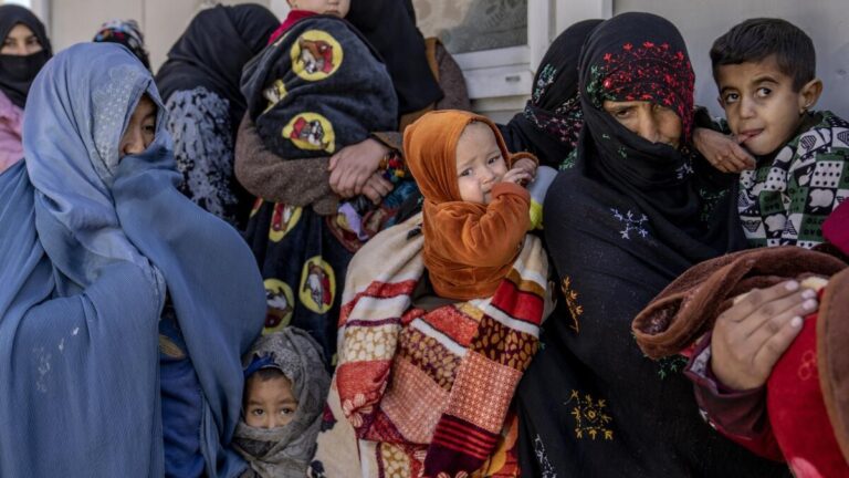 Afghan families queue outside a clinic as child malnutrition crisis deepens